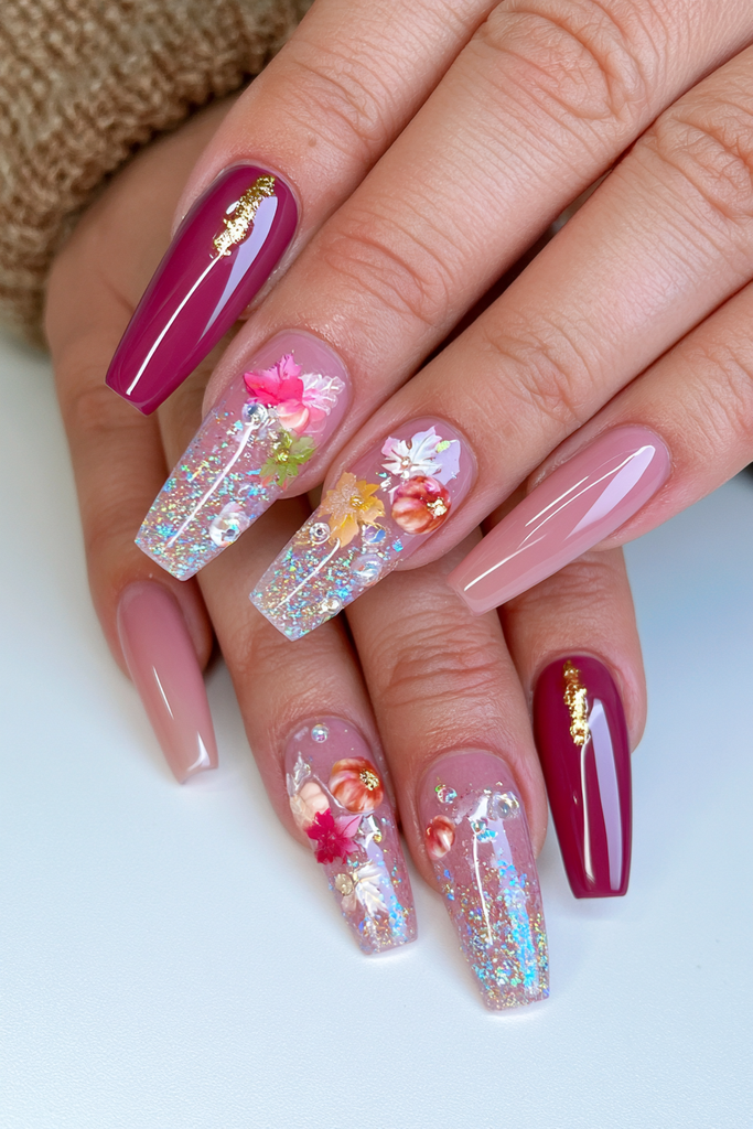Glamorous burgundy Thanksgiving nails with luxurious gold accents