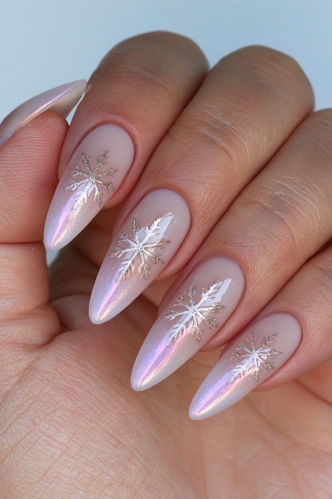 Elegant nails featuring gold-outlined snowflakes over a soft base