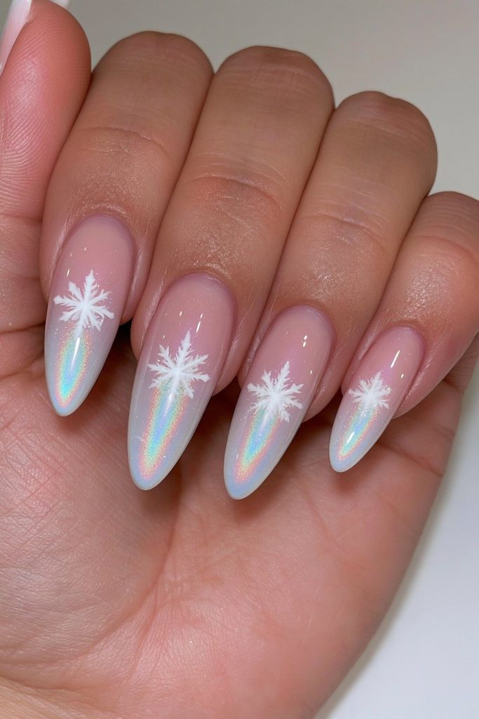 Holographic nails featuring shimmering snowflakes with iridescent rainbow reflections