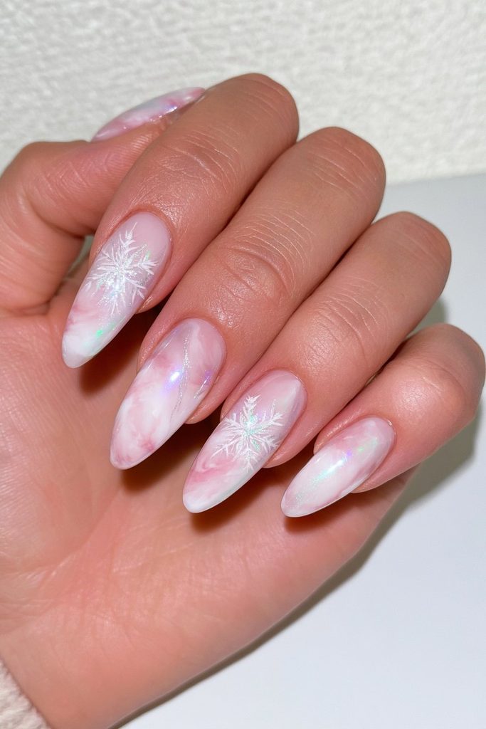 Marble nails layered with delicate white snowflake overlay designs