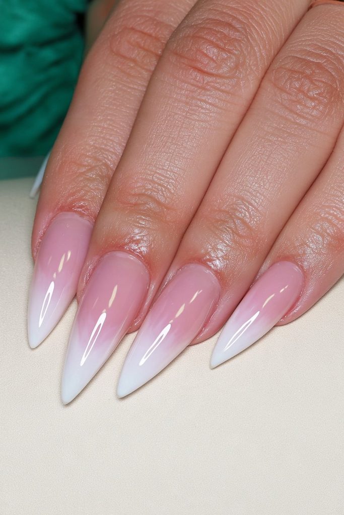 Milky nude stiletto nails with sheer glossy elegant finish