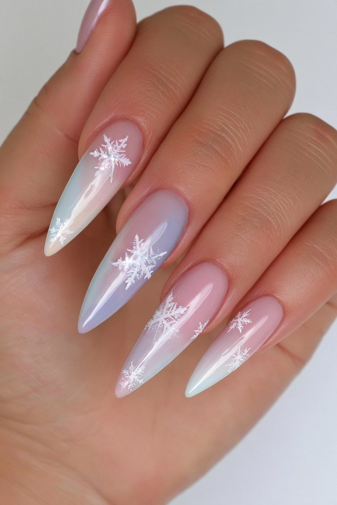 Pastel nails featuring soft colorful snowflakes and delicate winter accents