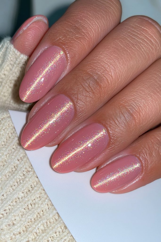 Pumpkin orange cat-eye nails with glowing seasonal magnetic shine