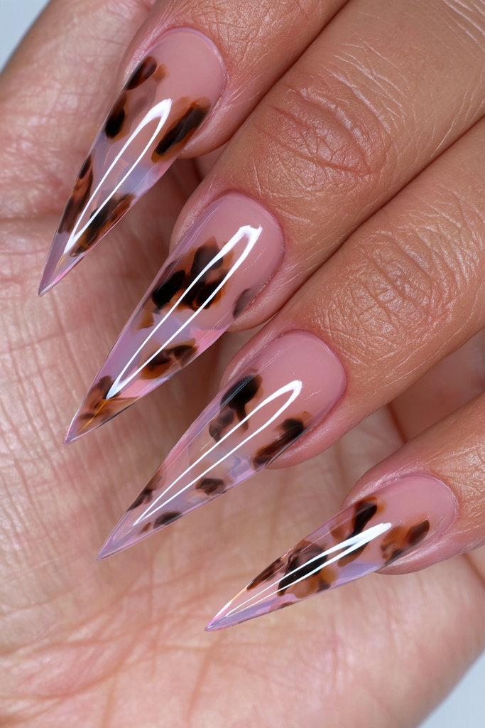 Sheer tortoiseshell stiletto nails with warm translucent patterning